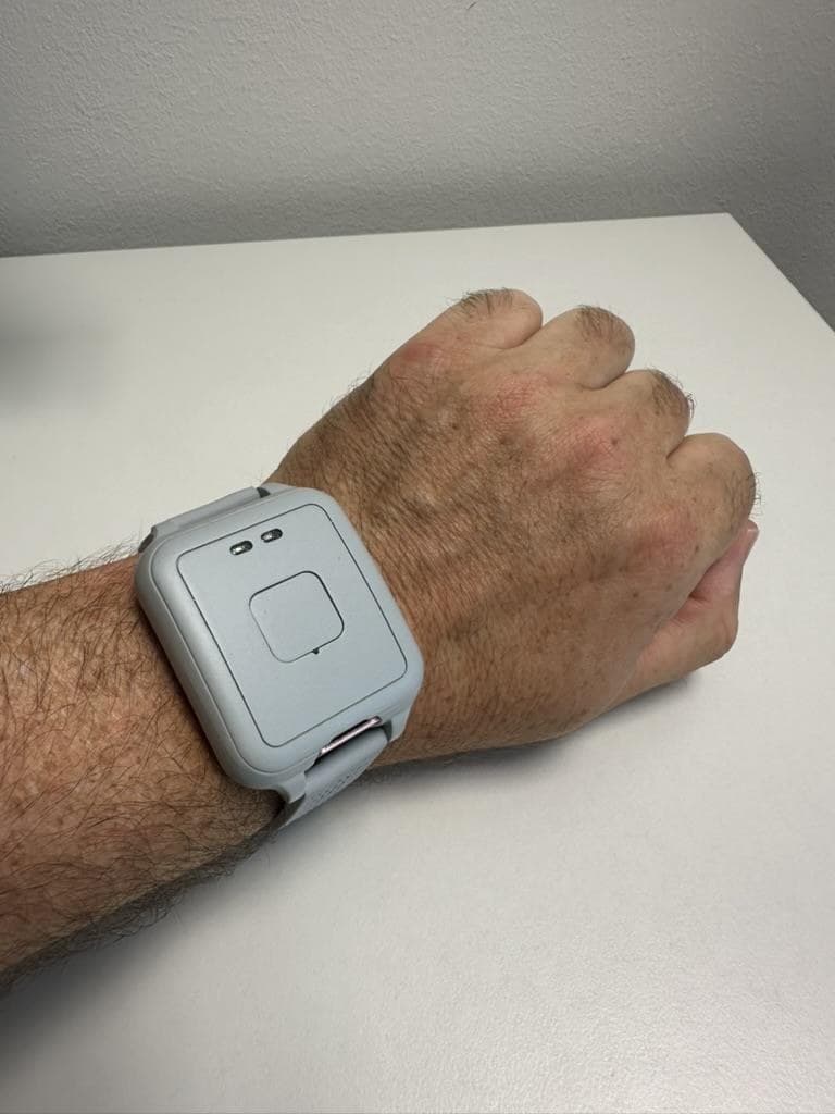 GCARE bracelet worn on a wrist, close-up